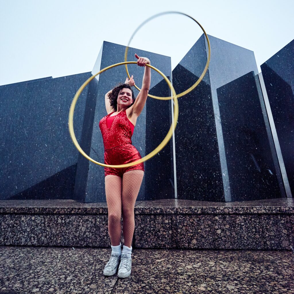 woman in red suit holding hula hoops